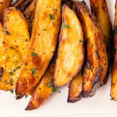 Herb Roasted Potatoes piled on a plate.